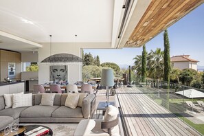 A modern living room with a sofa, coffee table, and dining area.