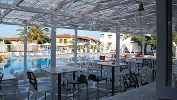 Outdoor pool, open 10:00 AM to 7:00 PM, pool umbrellas