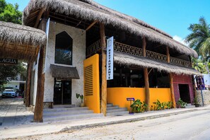 A two-story building with a thatched roof and a sign indicating a restaurant. - Diosa del Agua Bacalar (Bacalar)