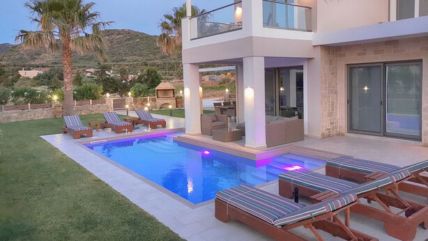 A modern two-story house with a swimming pool, outdoor seating, and a view of the surrounding landscape. - Alexandros villa with private pool (Νωπήγεια)