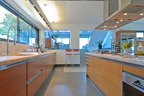 Enjoy cooking in this well-equipped kitchen with a large island and bar stools, oven, and dishwasher.