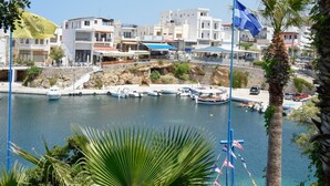 A coastal town with modern buildings, a marina with boats, and a clear blue sky. - Villa Karmilos - A family Villa near the cretan sea and the mountains (Sissi)