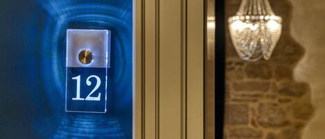 A digital display with the number 12, a door frame, and a chandelier.