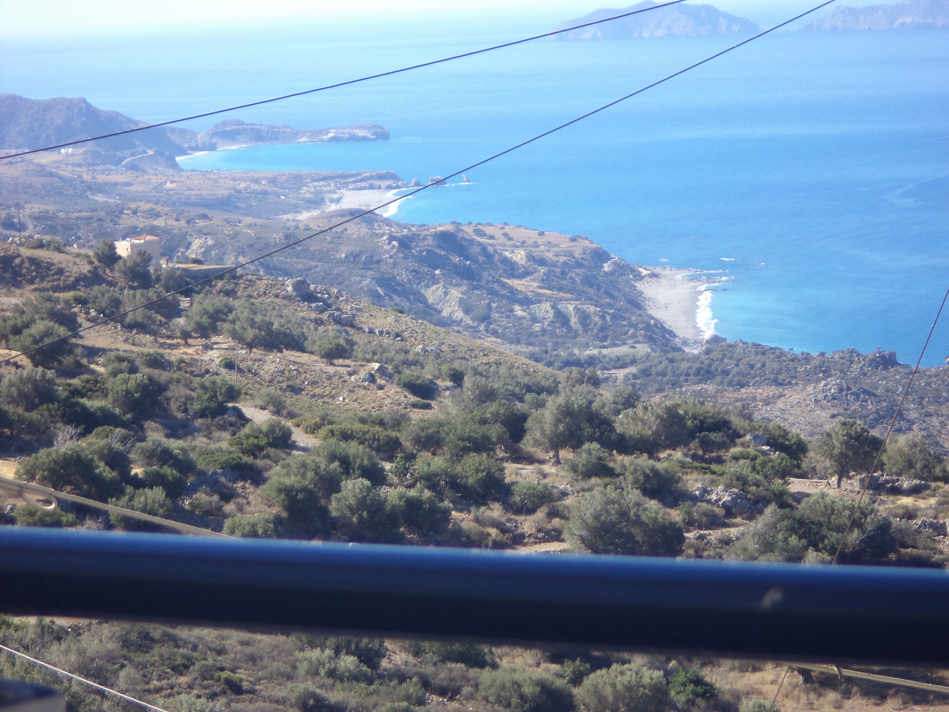A mountainous landscape with a coastal view.