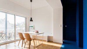 A modern dining area with a table, chairs, and a pendant light. - Modern 2 bed/2 bath Acropolis view flat (Αθήνα)