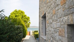 A stone building with a narrow pathway leading to a scenic view. - A Family Friendly Sea View Villa. Cycling Walking Fishing Birdwatcing Swimming (Πηγαδάκια)