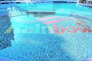Ein Schwimmbad mit gefliestem Boden und Metallgeländer.