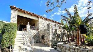 A stone building with a tiled patio and a staircase leading to a balcony. - Eros villa ,private Pool,short drive to beach (Rethymno)
