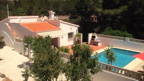 A residential property with a swimming pool, a covered patio, and a view of a hilly landscape. - Private Villa With Pool Near Golf Course Short Drive to Beach (Unknown)