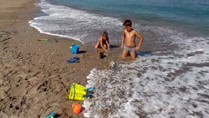 A beach with children playing, a blue bucket, and a yellow bucket. - Arch Villa traditional holiday house on Rhodes (Σορωνή)