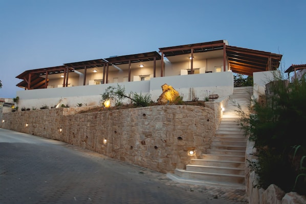 Enjoy the hotel's outdoor area with a stone wall and steps leading up to the entrance.