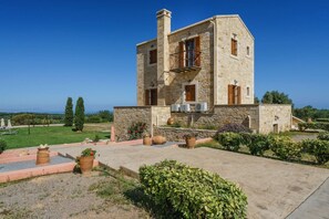 A stone building with a balcony, surrounded by a garden and a clear view of the sea. - Wedding Villa w/Pool, BBQ, Ping Pong, 23 people (Πικρής)