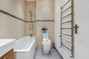 Bathtub, eco-friendly toiletries, hair dryer, towels