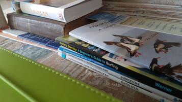 A stack of books on a wooden surface.
