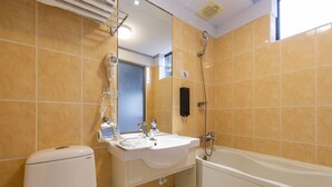 A modern bathroom with a white sink, a toilet, and a bathtub. - Peng Apartment (Taipei)