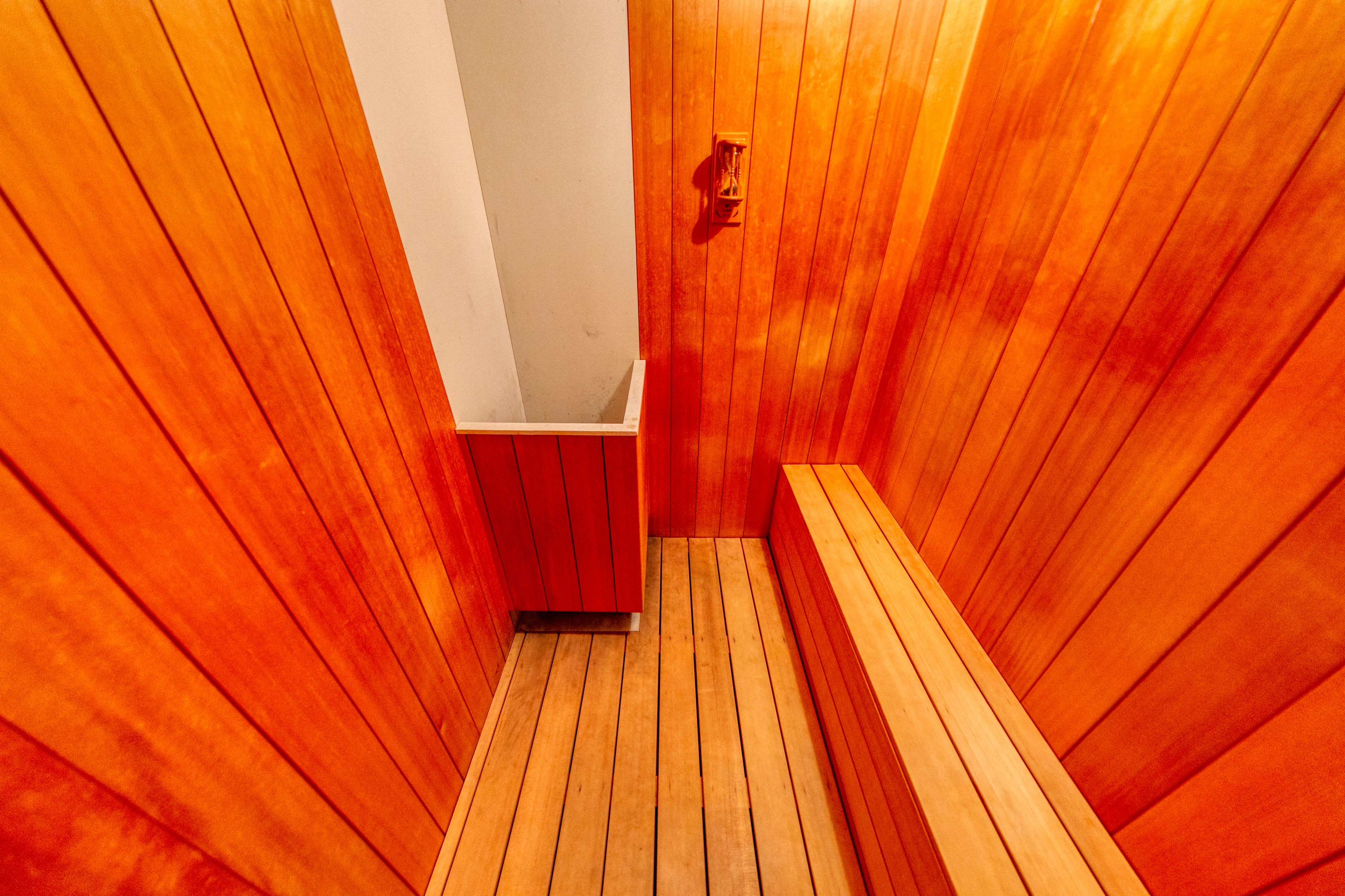 A sauna with wooden walls and benches.