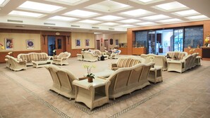 A spacious lobby with multiple seating areas, a reception desk, and a large glass door leading outside. - Life Leisure Resort (Guanxi)