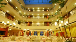 A multi-level banquet hall with round tables, white chairs, and a central balcony. - Life Leisure Resort (Guanxi)