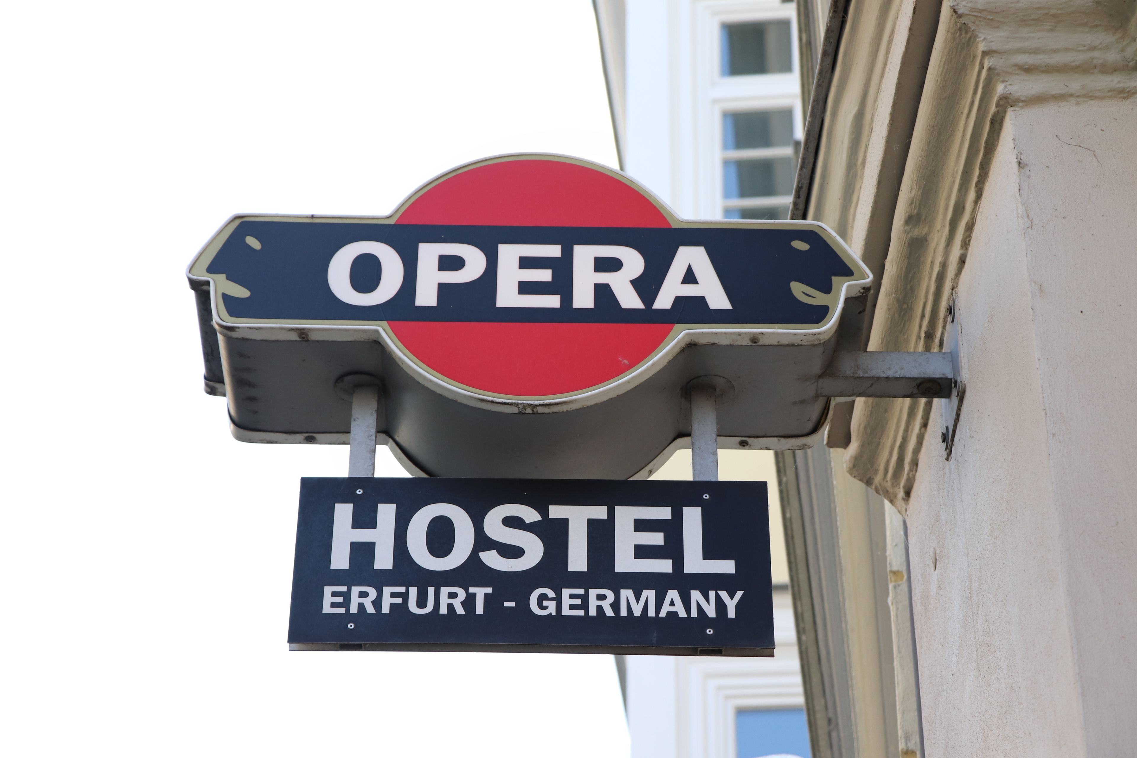A sign with "OPERA" and "HOSTEL ERFURT - GERMANY" indicating a hostel near an opera venue.