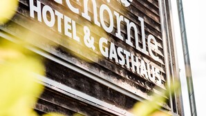 A wooden sign with the text "Seehornle HOTEL & GASTHAUS" and a logo.