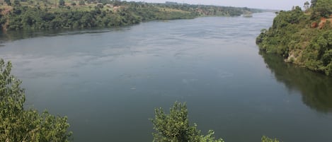 A river with surrounding greenery and hills.
