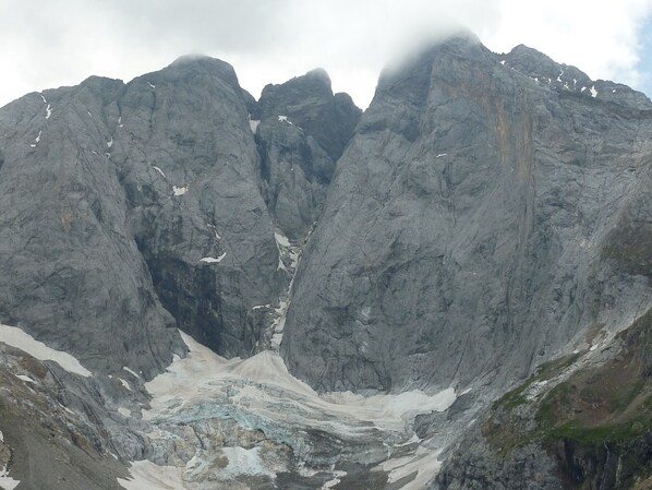 A mountainous landscape with a glacier.