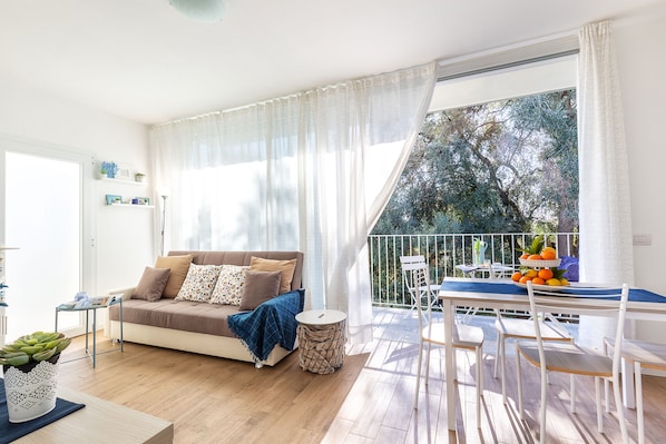 Apartment, 2 Bedrooms | Living area | Flat-screen TV - Residence Olivastro Vista Mare (Baunei)