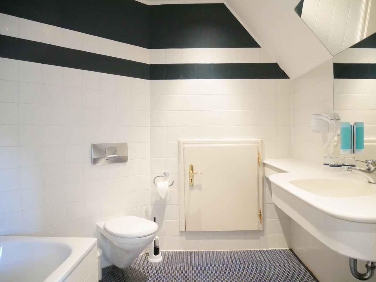 Ein modernes Badezimmer mit Toilette, Waschbecken und Badewanne.