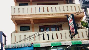 A multi-story building with a balcony on the upper floor.