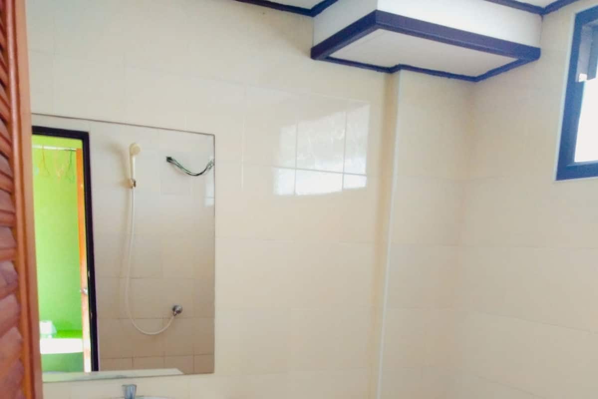 A bathroom with a sink, toilet, and a shower.