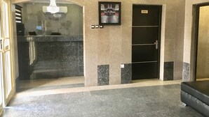 A lobby with a reception desk, a framed picture on the wall, and a door labeled "OFFICE". - Elicris Hotel (Lagos)