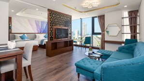 A modern hotel room with a large bed, a sofa, a TV, and a city view. - CN Palace Boutique Hotel & Spa (Da Nang)