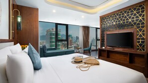 A modern hotel room with a large bed, a TV, a city view, and a wooden accent wall. - CN Palace Boutique Hotel & Spa (Da Nang)