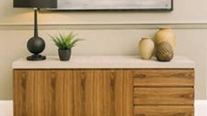 A wooden cabinet with a black lamp, a small plant, and two vases on top. - JOIVY Palmerston Place Residence: Luxury City Centre Apt With Private Parking (Edinburgh)