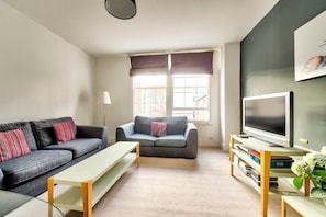 Apartment (1 Bedroom) | Living room | 24-inch flat-screen TV with cable channels