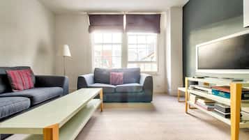 Apartment (1 Bedroom) | Living room | 24-inch flat-screen TV with cable channels