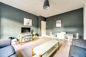 Apartment (1 Bedroom) | Living room | 24-inch flat-screen TV with cable channels