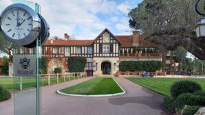 A historic building with a clock, a sign reading "Old Course Golf," and a well-maintained lawn. - Cannes Mandelieu villa with private pool. (Mandelieu-la-Napoule)