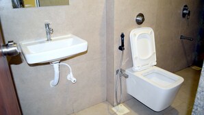 A bathroom with a sink, toilet, and shower. - Hotel Kuber by Sky Stays (Dwarka)