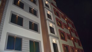 A multi-story hotel with a sign reading "HOTELDEVKI NANDAN". - Hotel Kuber by Sky Stays (Dwarka)