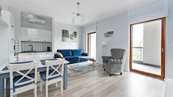 A modern living space with a kitchen, dining area, and seating area.