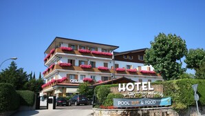 A hotel with a sign indicating a pool bar and food. - Parc Hotel Casa Mia (Lazise)
