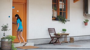 A person entering a building through a wooden door. - BikeSki B&B (Mežica)