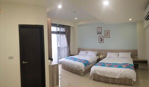A hotel room with two beds, a dark door, a window with curtains, and a light-colored wall with framed pictures. - TungShiang (Sanyi)