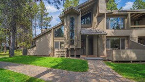 A modern two-story house with a paved driveway and a well-maintained lawn. - Tennis Village Escape with Access to Exclusive Golf (Bend)