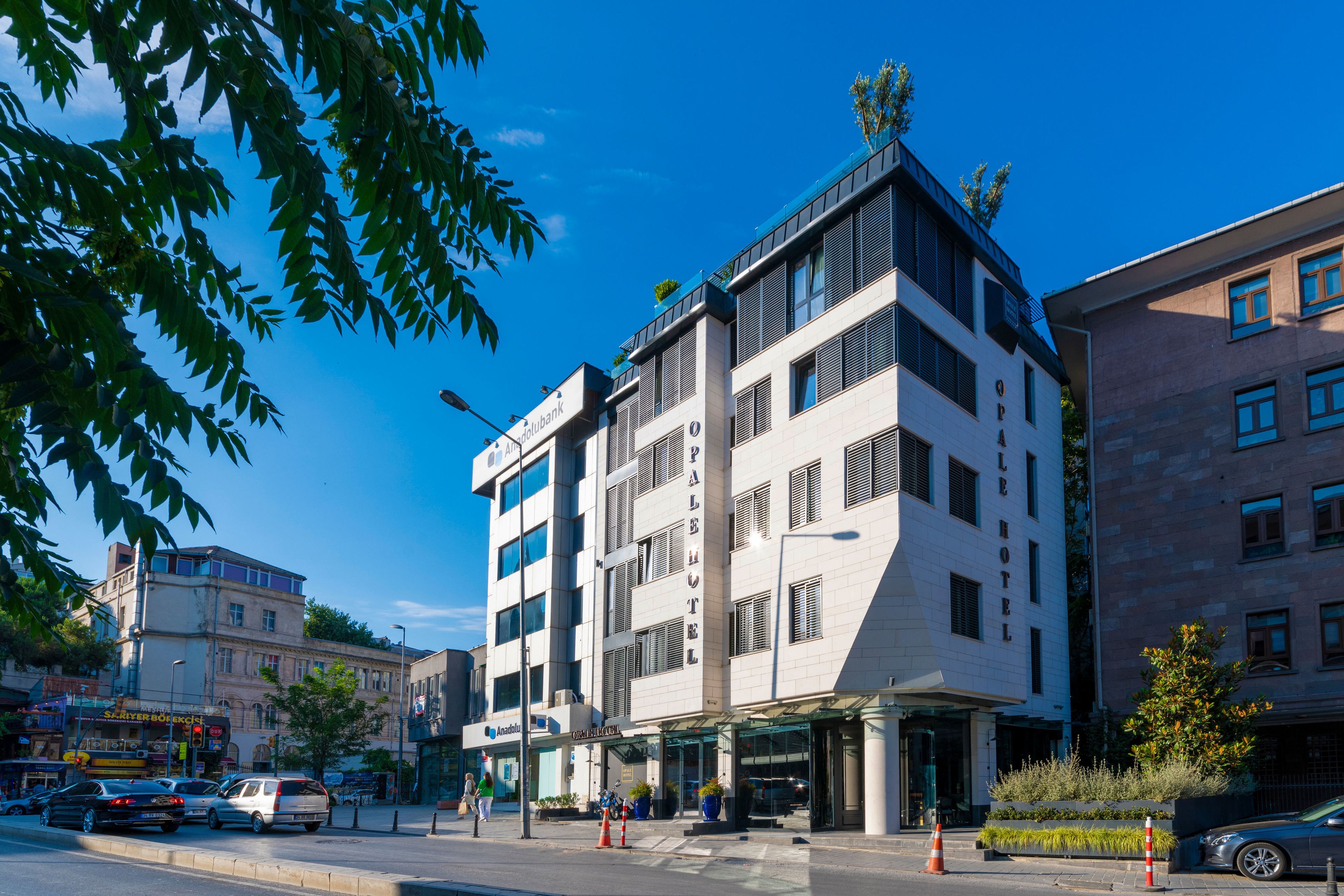 A modern hotel with a prominent 'Palace Hotel' sign, multiple floors, and a glass entrance.