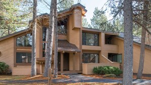 A modern two-story house with a sloped roof, large windows, and a wooden exterior. - Tennis Village Escape with Access to The Cove (Sunriver)