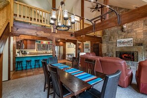 Cozy seating area with a stone fireplace and comfortable sofas.