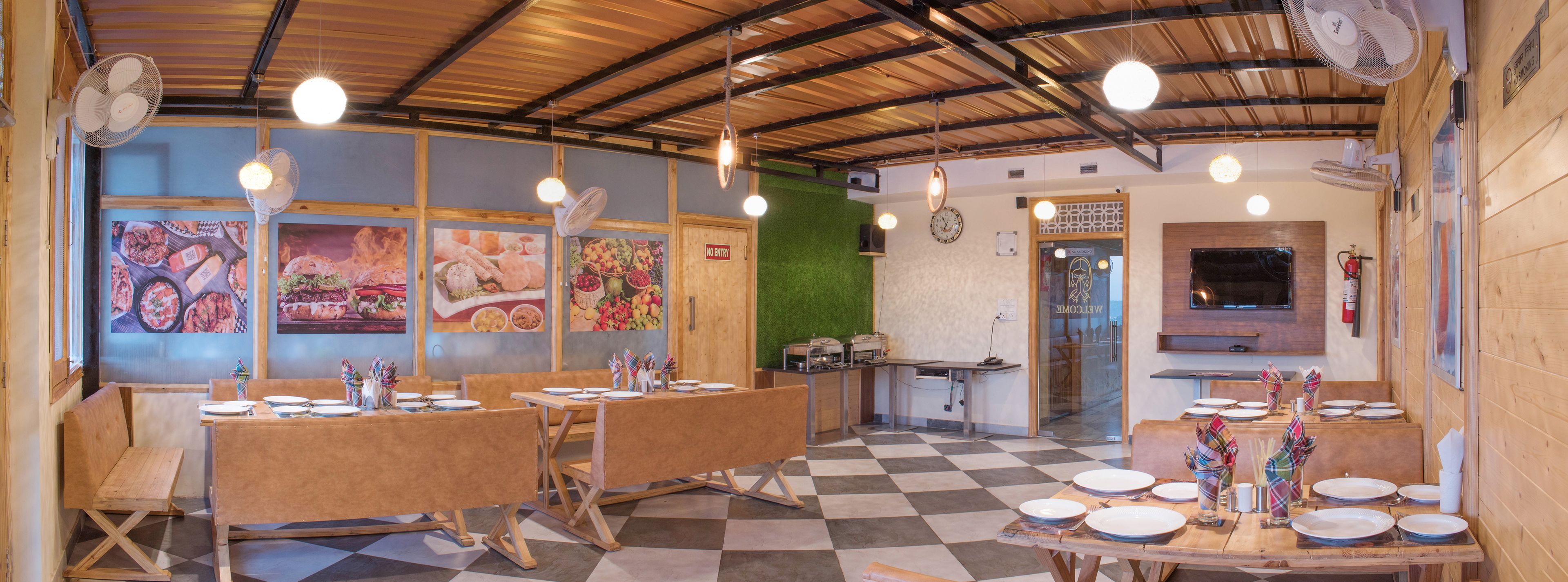 A restaurant with wooden tables and chairs, a checkered floor, and wall art.