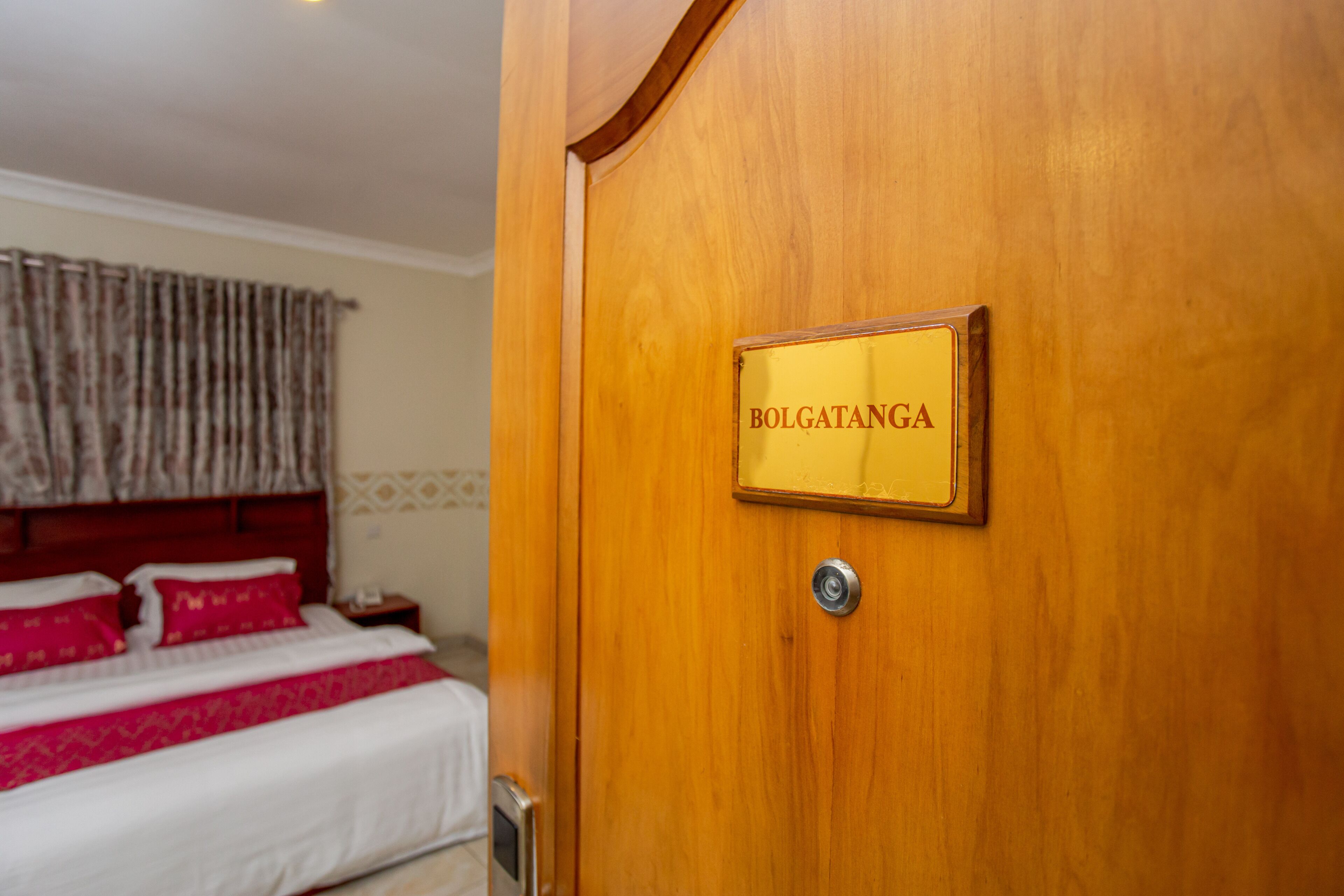 A wooden door with a sign that reads "BOLGATANGA".